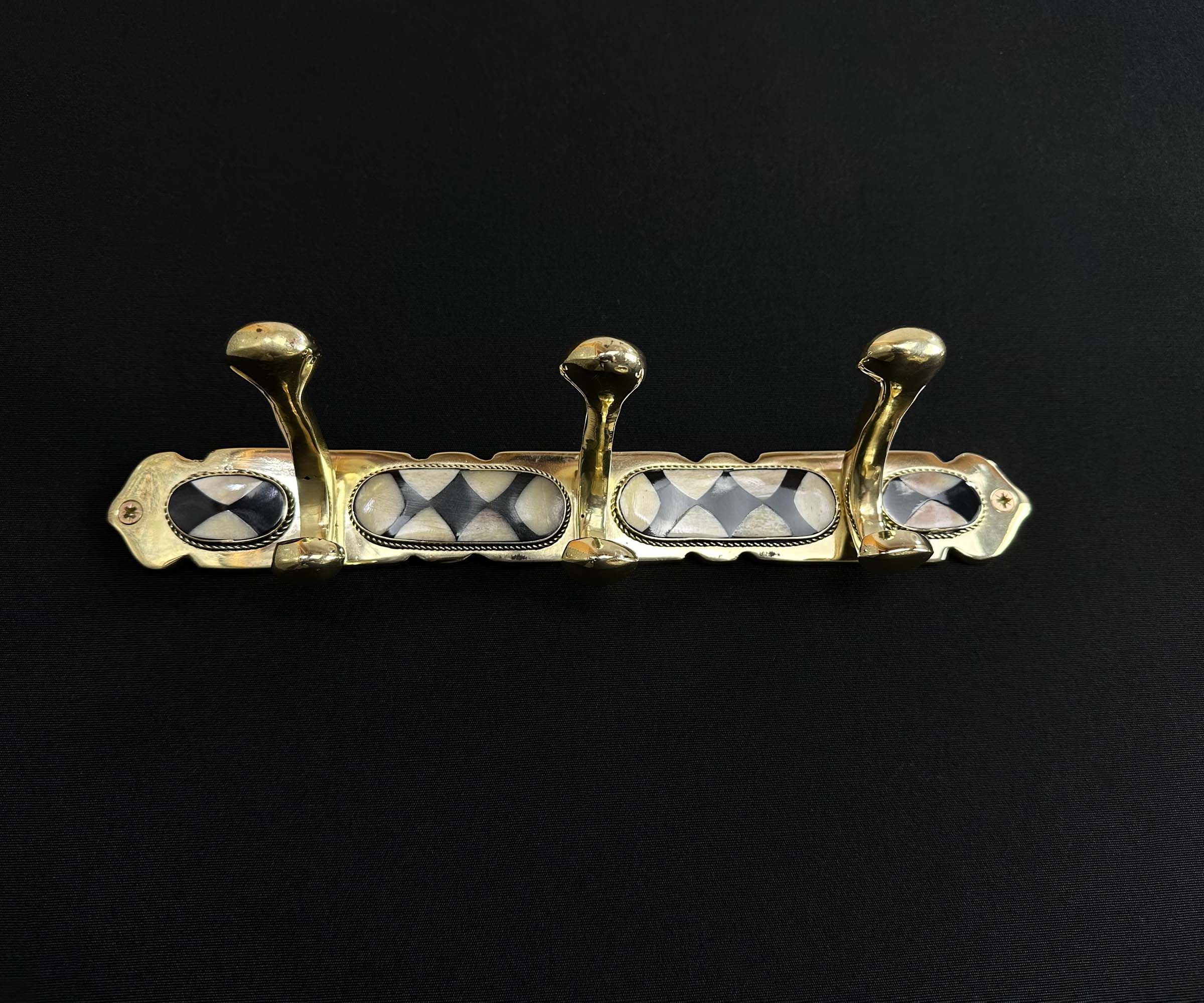 Solid brass wall hook with unique black resin and bone inlay.