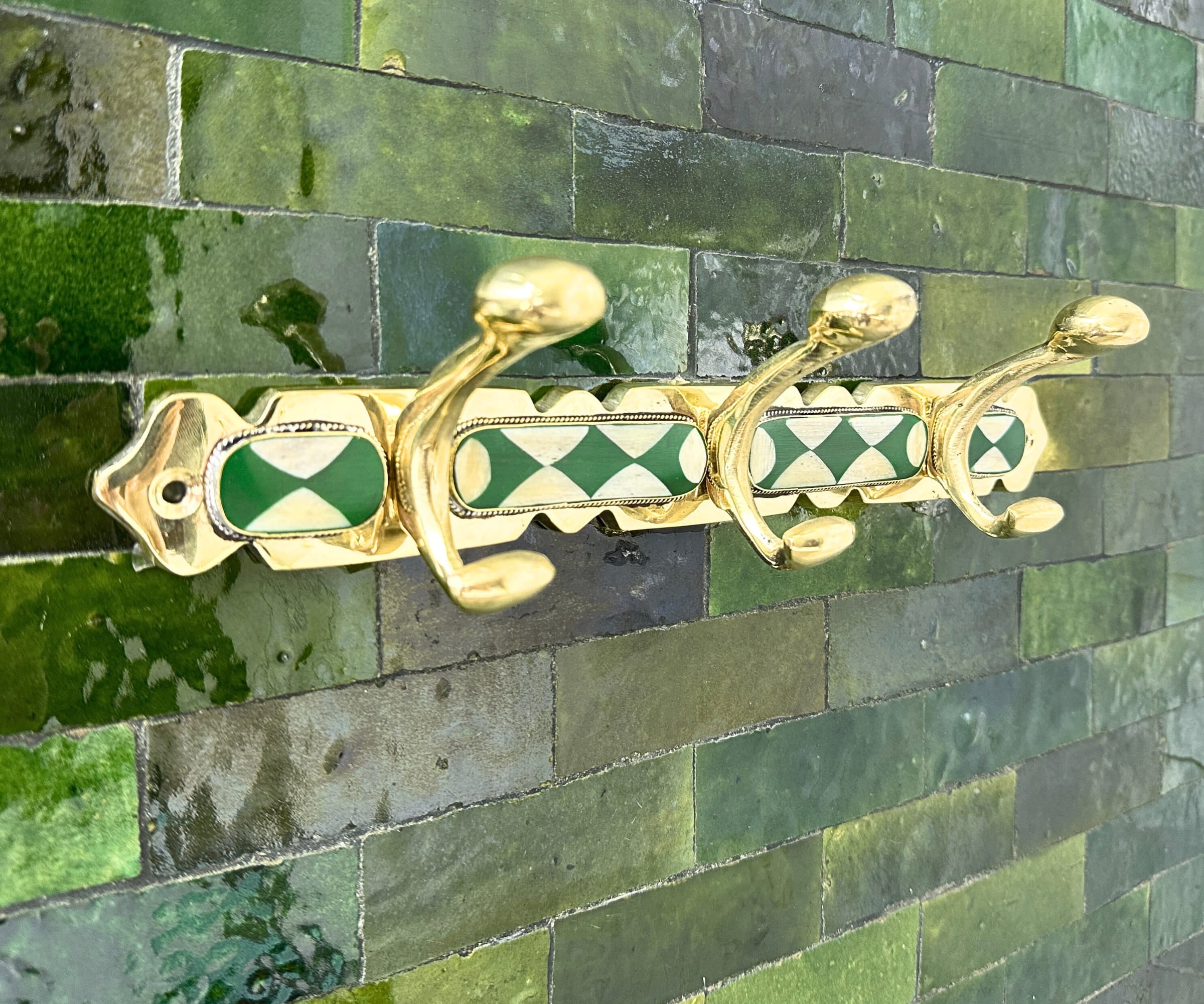 Handmade brass wall hooks with white and green resin inlay by LuxeBrass