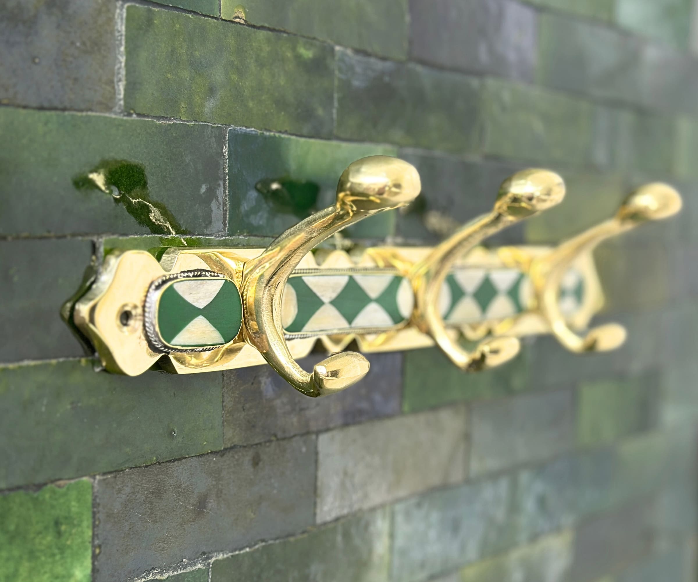 Handmade brass wall hooks with white and green resin inlay by LuxeBrass