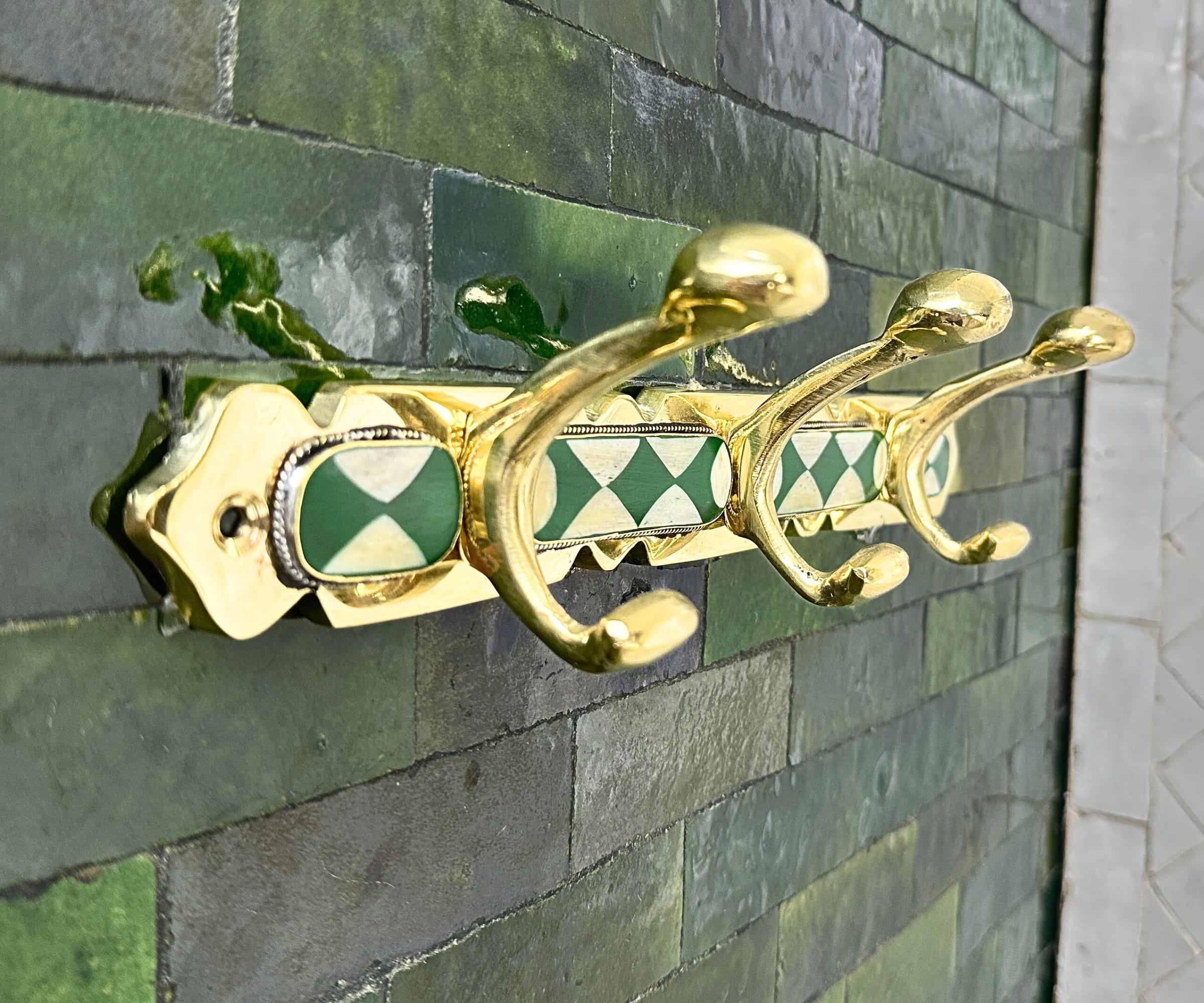 Handmade brass wall hooks with white and green resin inlay by LuxeBrass