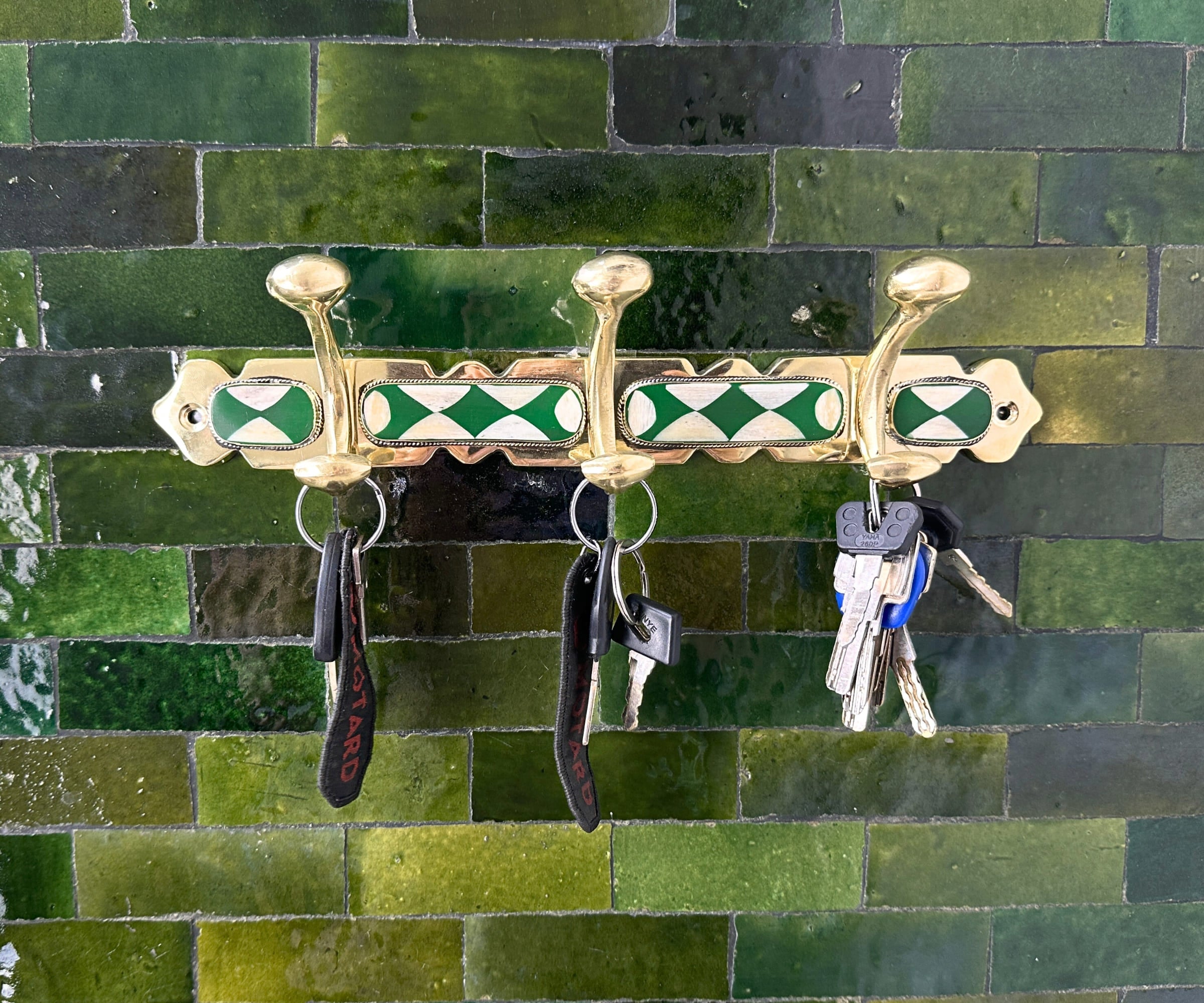 Handmade brass wall hooks with white and green resin inlay by LuxeBrass