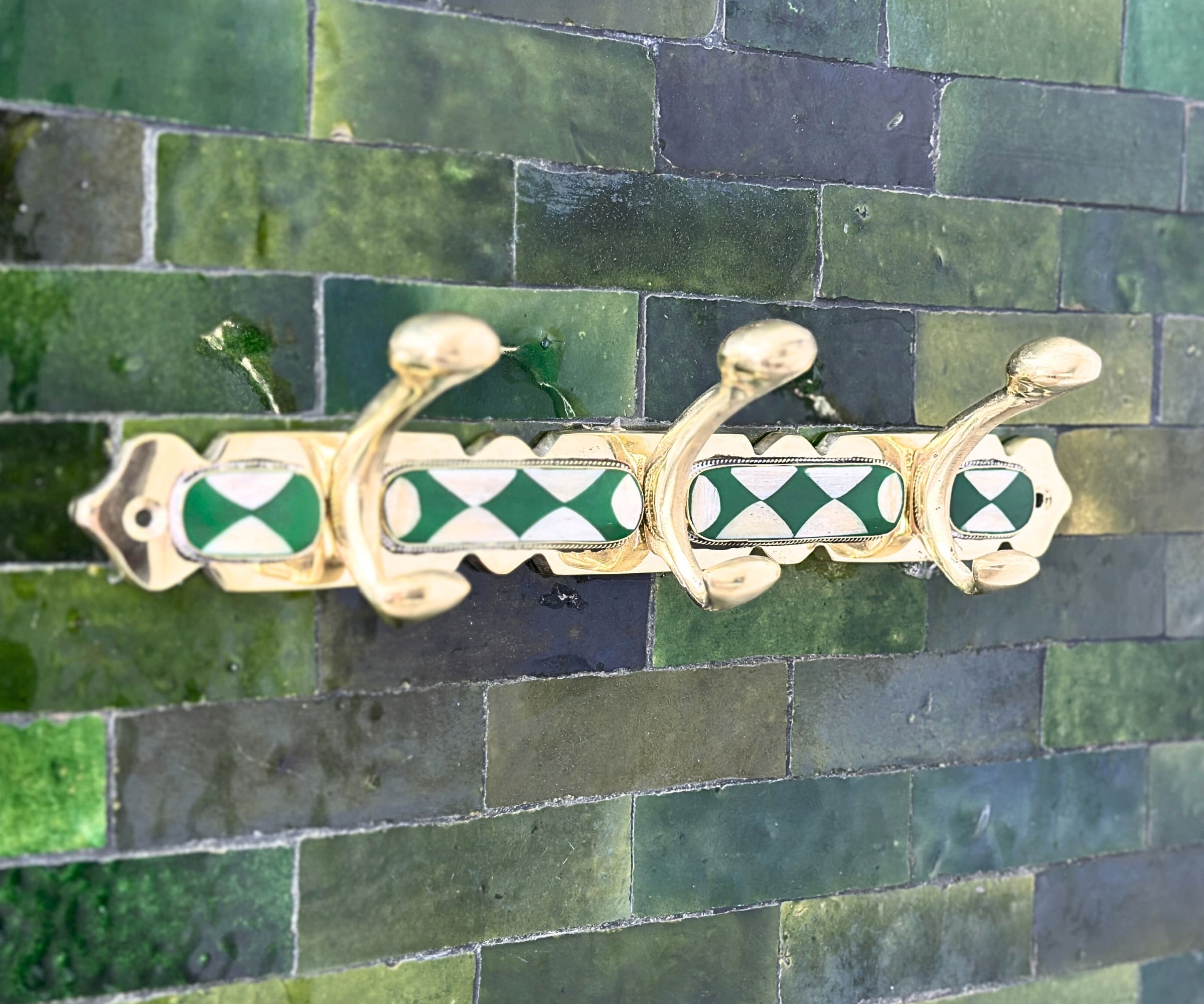 Handmade brass wall hooks with white and green resin inlay by LuxeBrass