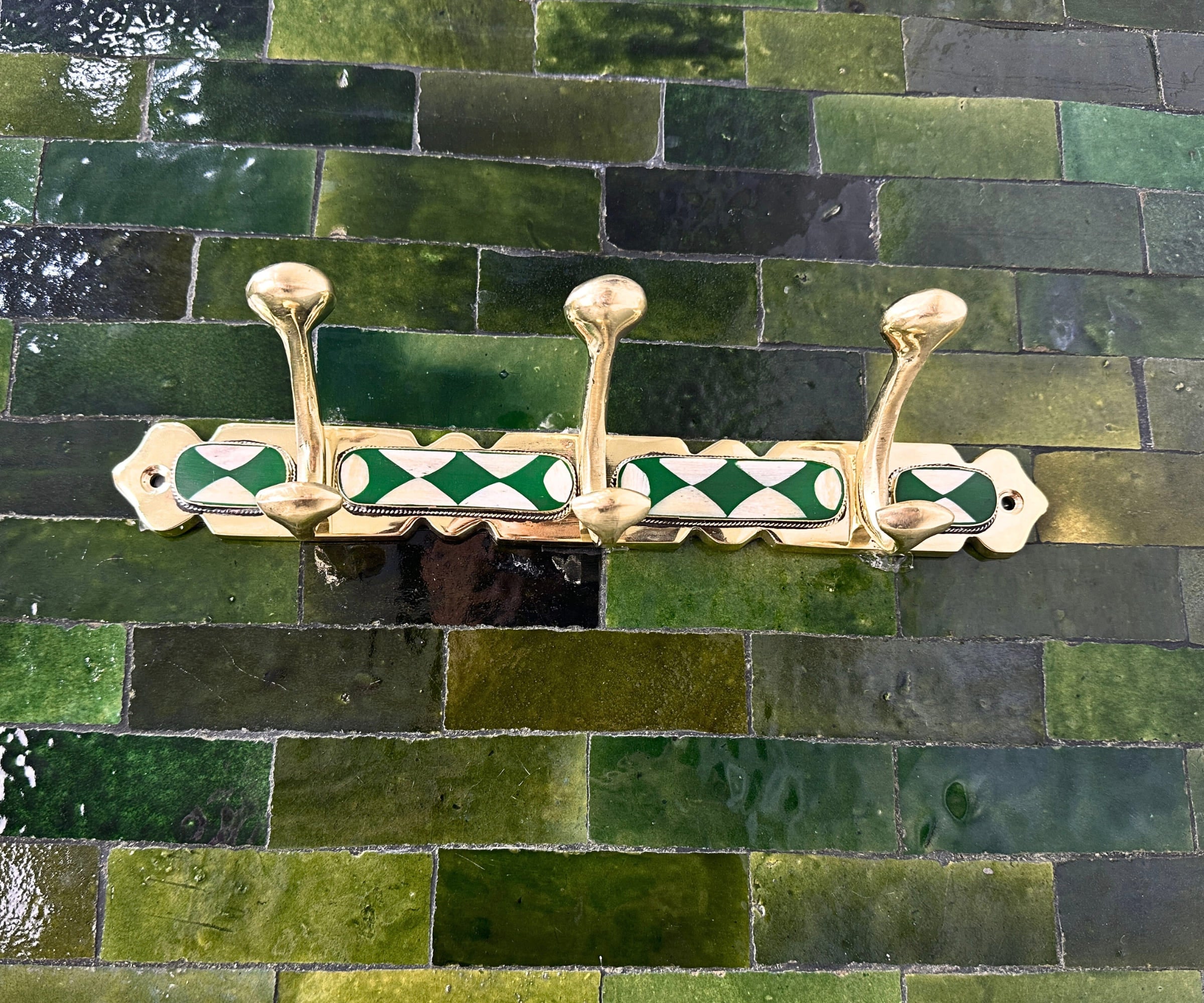 Handmade brass wall hooks with white and green resin inlay by LuxeBrass
