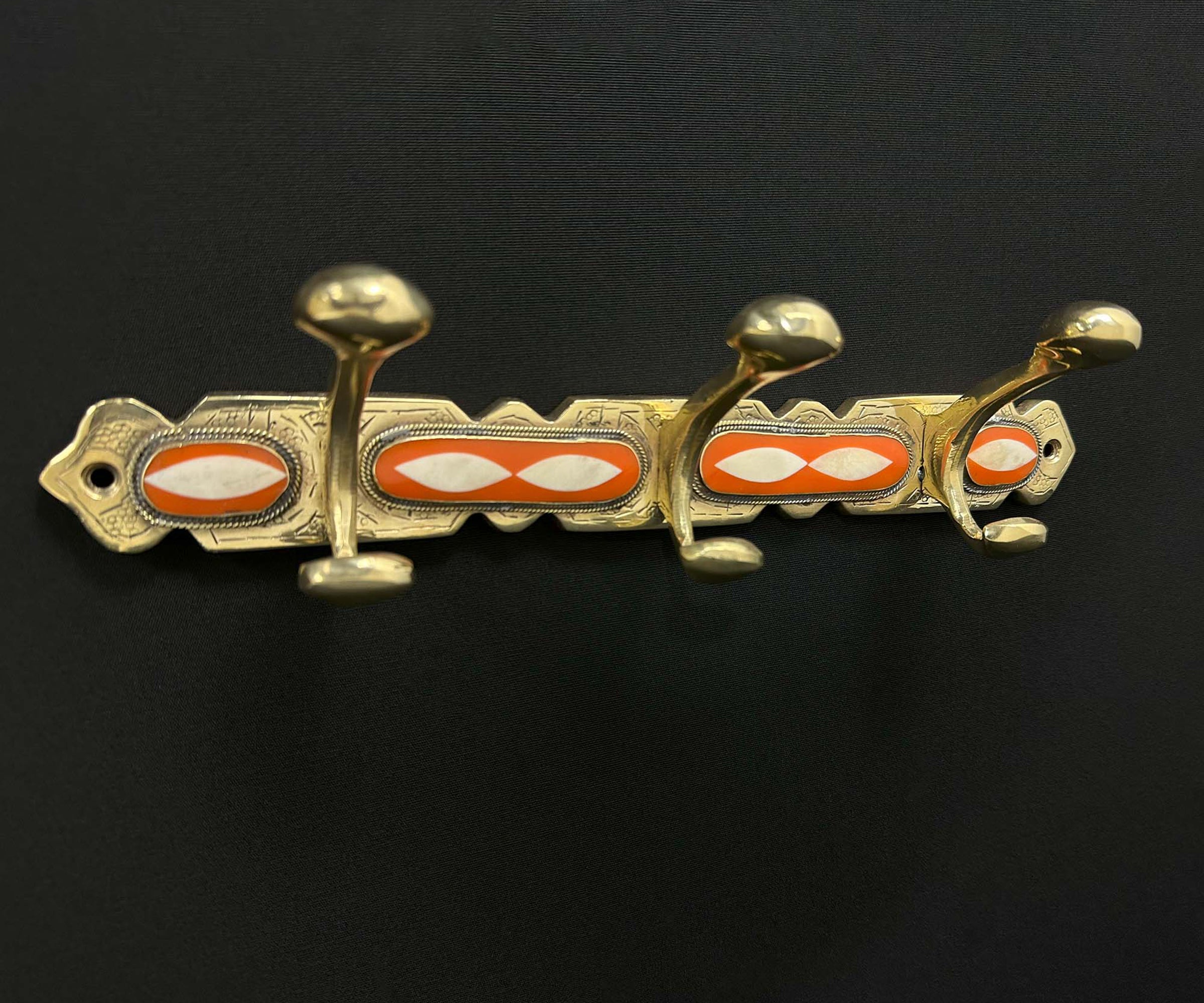 Close-up of Handmade Brass Hook with Orange Resin Inlay