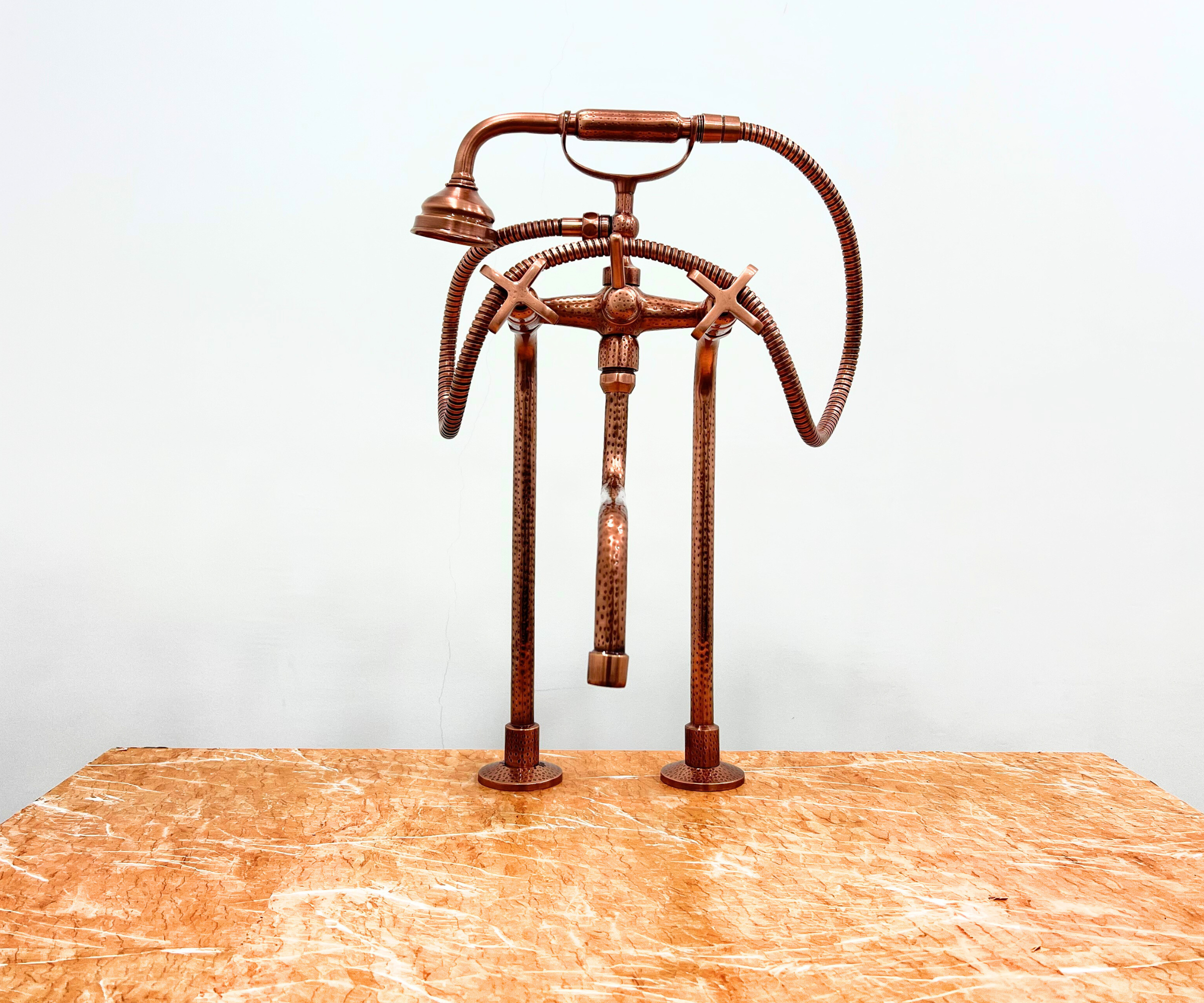 Close-up of Brass Freestanding Tub Faucet with Handheld Shower and Copper Finish