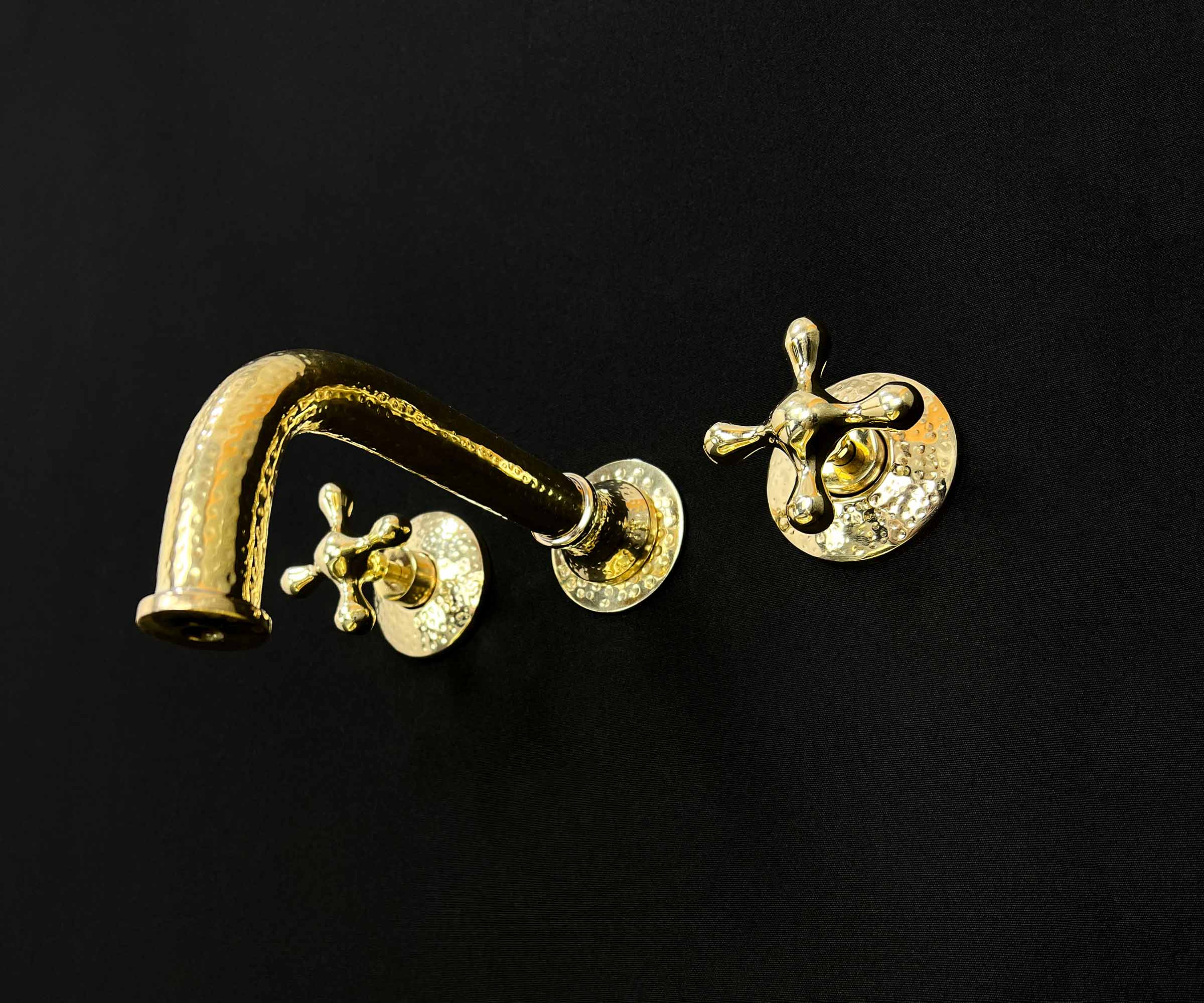 Brass faucet mounted on a stylish bathroom wall