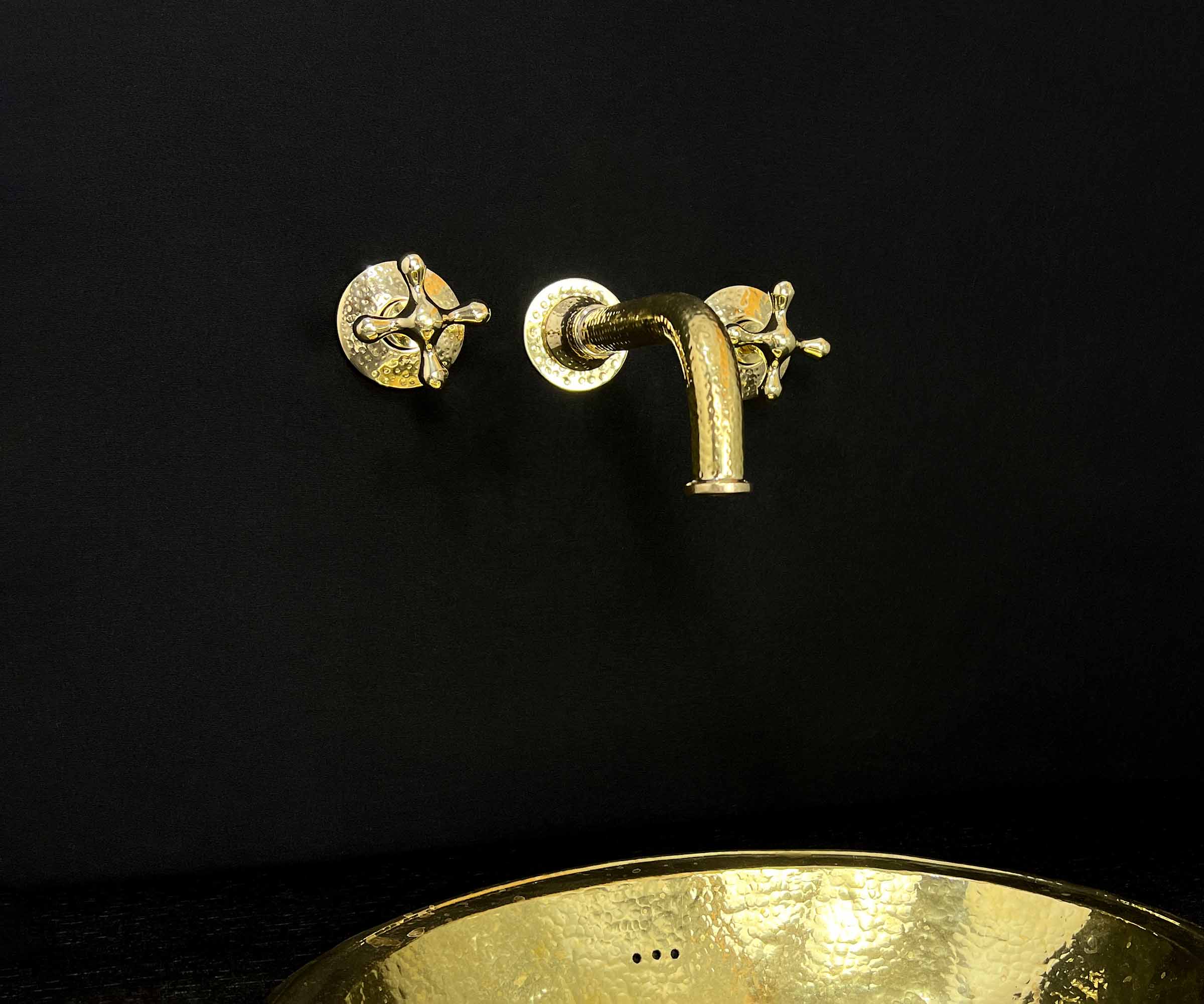 Water flowing from a luxury brass faucet in a contemporary bathroom