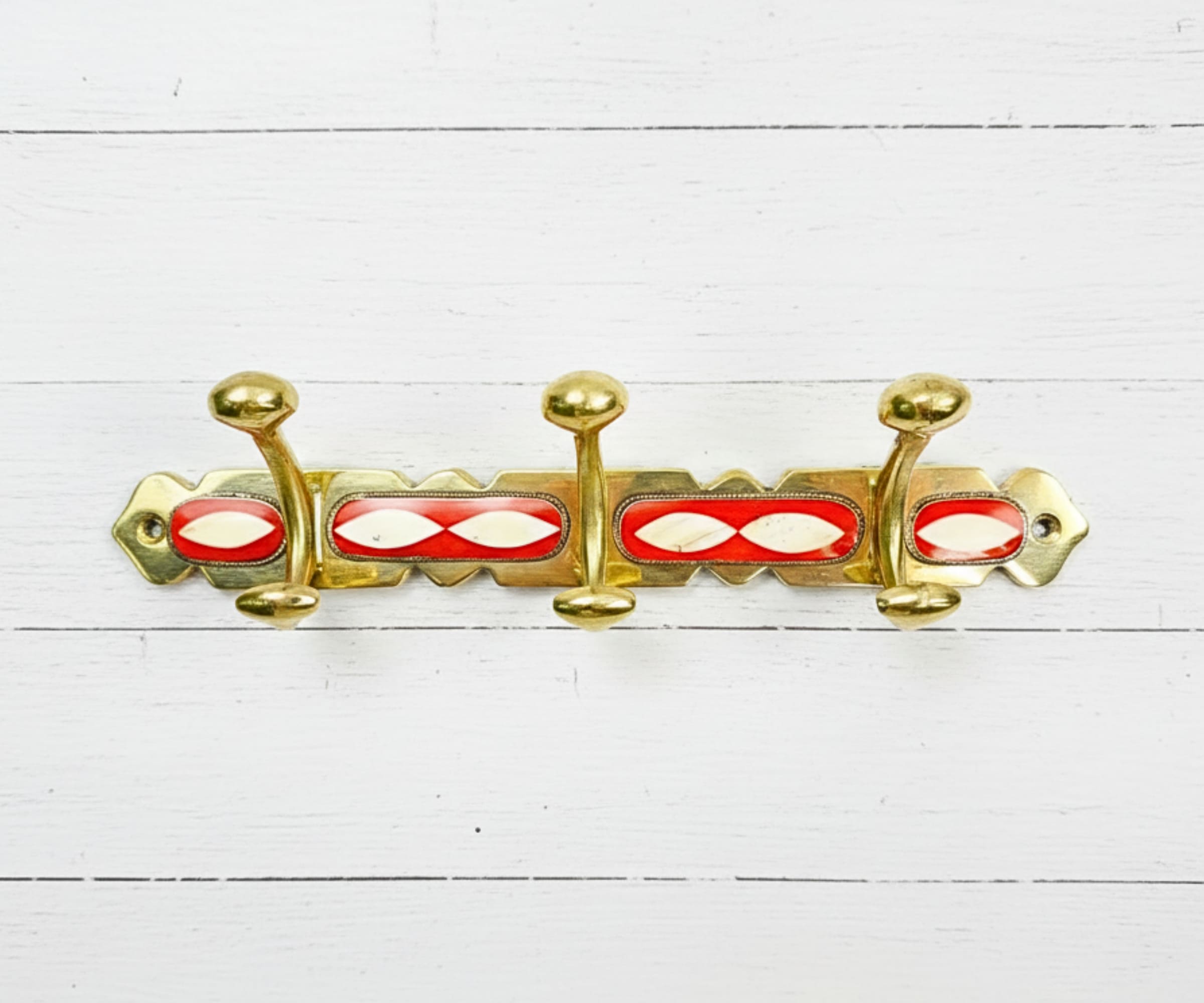 Handcrafted brass wall hooks with white and orange resin inlay by LuxeBrass
