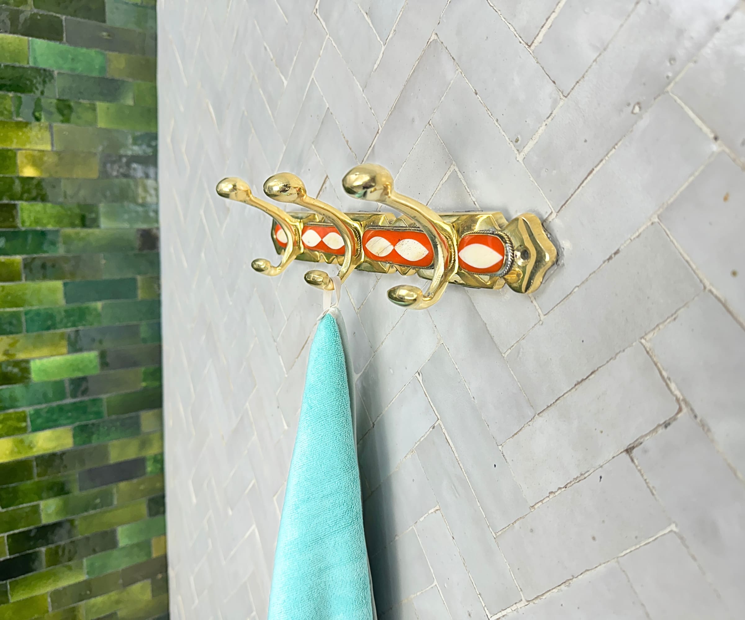 Handcrafted brass wall hooks with white and orange resin inlay by LuxeBrass