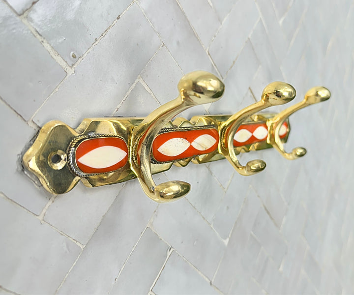 Handcrafted brass wall hooks with white and orange resin inlay by LuxeBrass