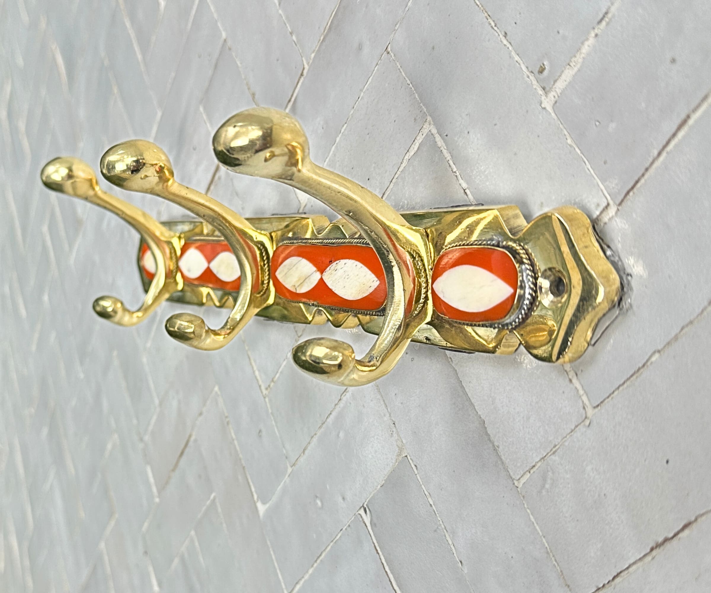 Handcrafted brass wall hooks with white and orange resin inlay by LuxeBrass