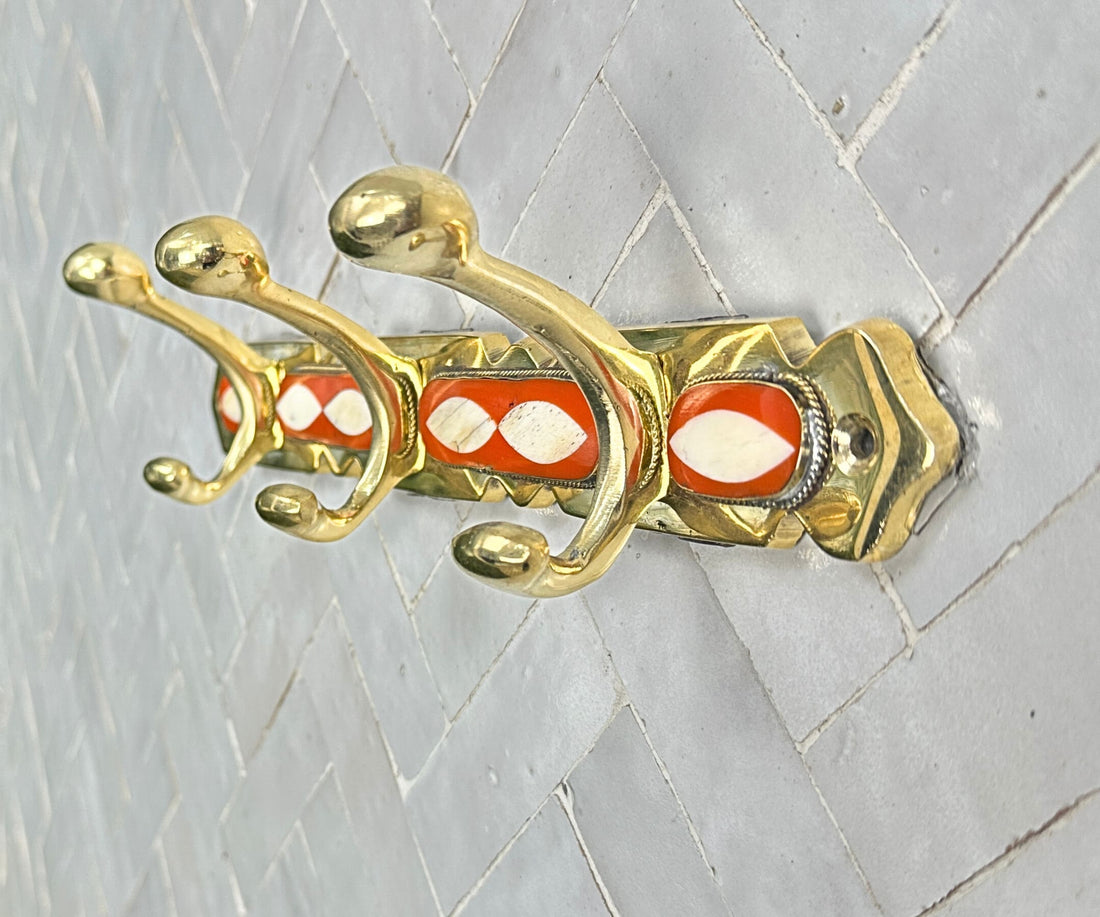 Handcrafted brass wall hooks with white and orange resin inlay by LuxeBrass