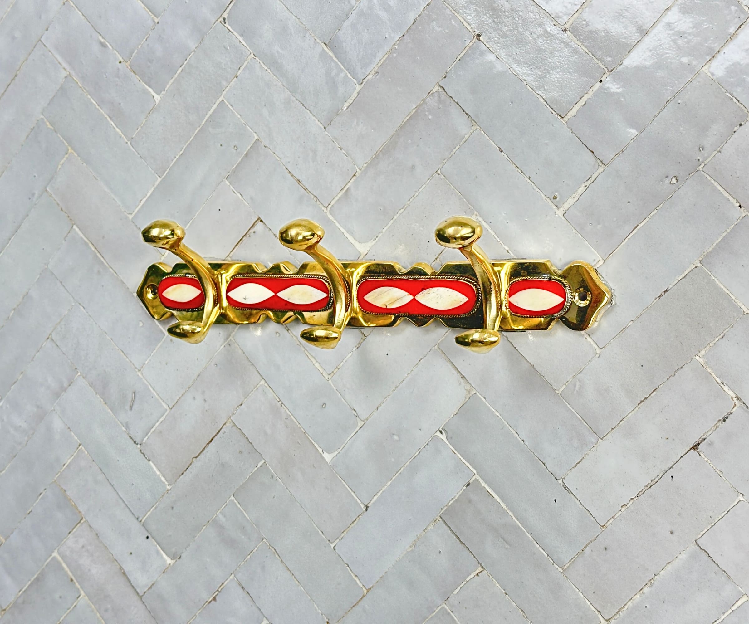 Handcrafted brass wall hooks with white and orange resin inlay by LuxeBrass