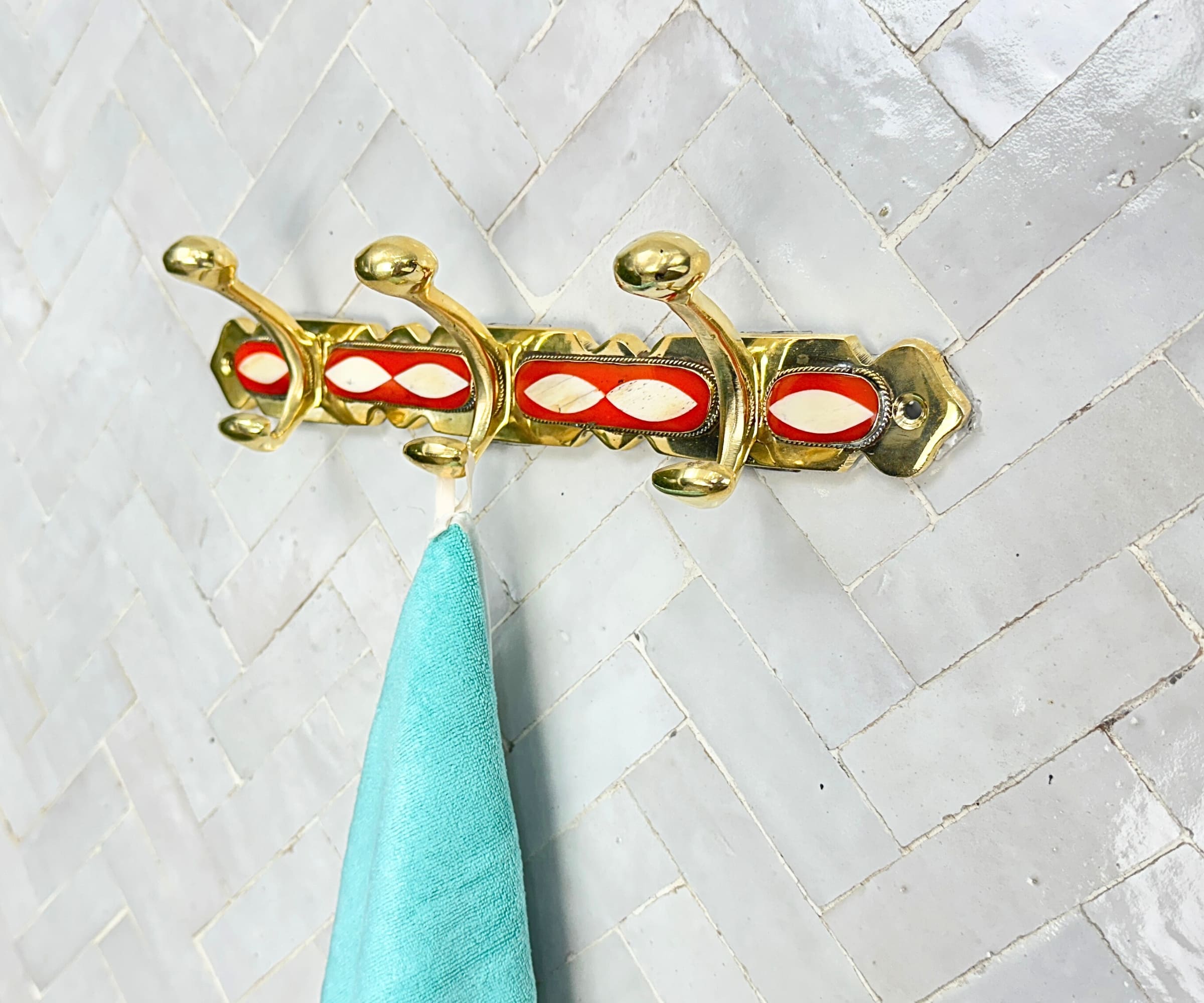 Handcrafted brass wall hooks with white and orange resin inlay by LuxeBrass