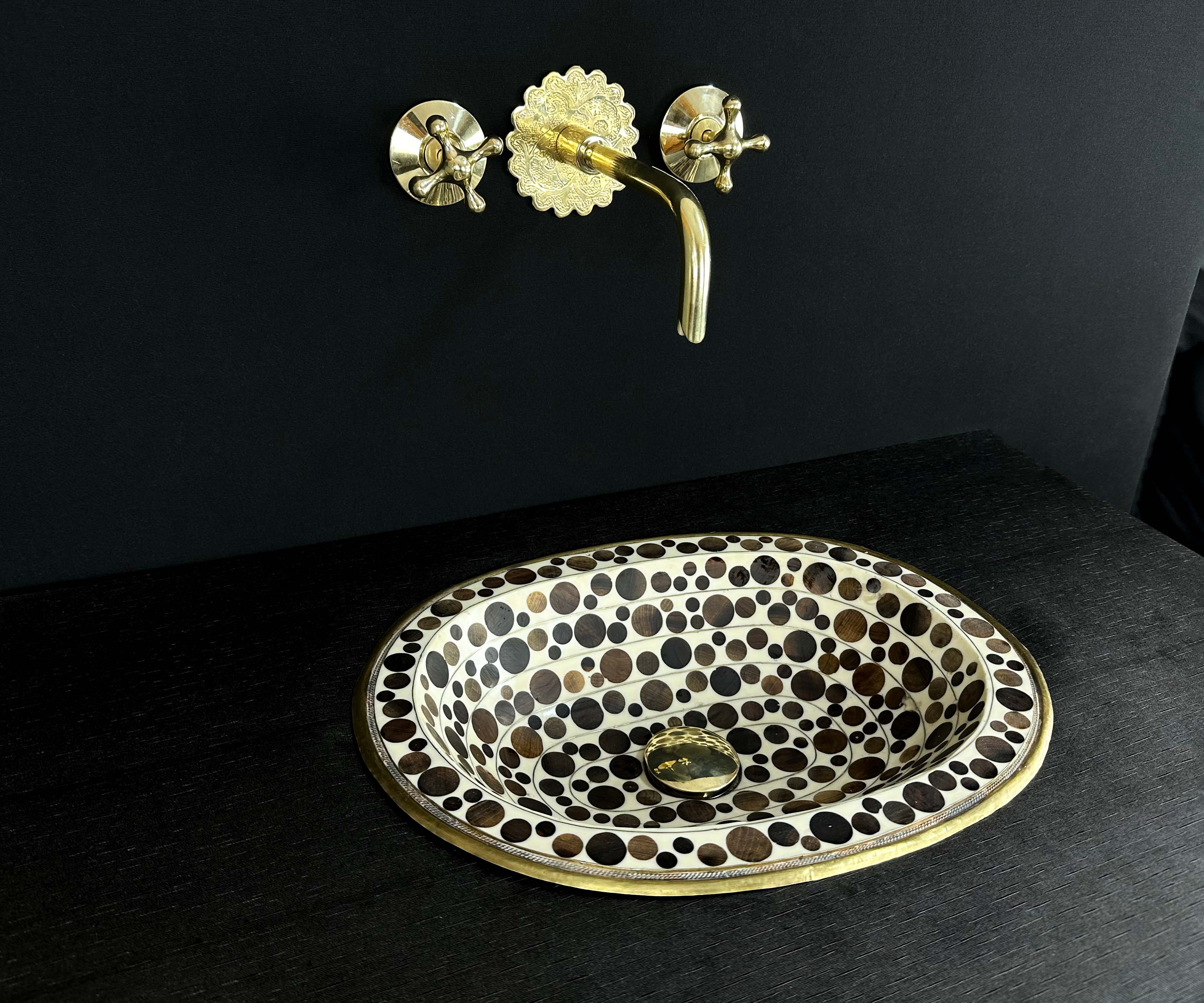 Oval Brass Sink with Circular Wood and White Resin Accents 
