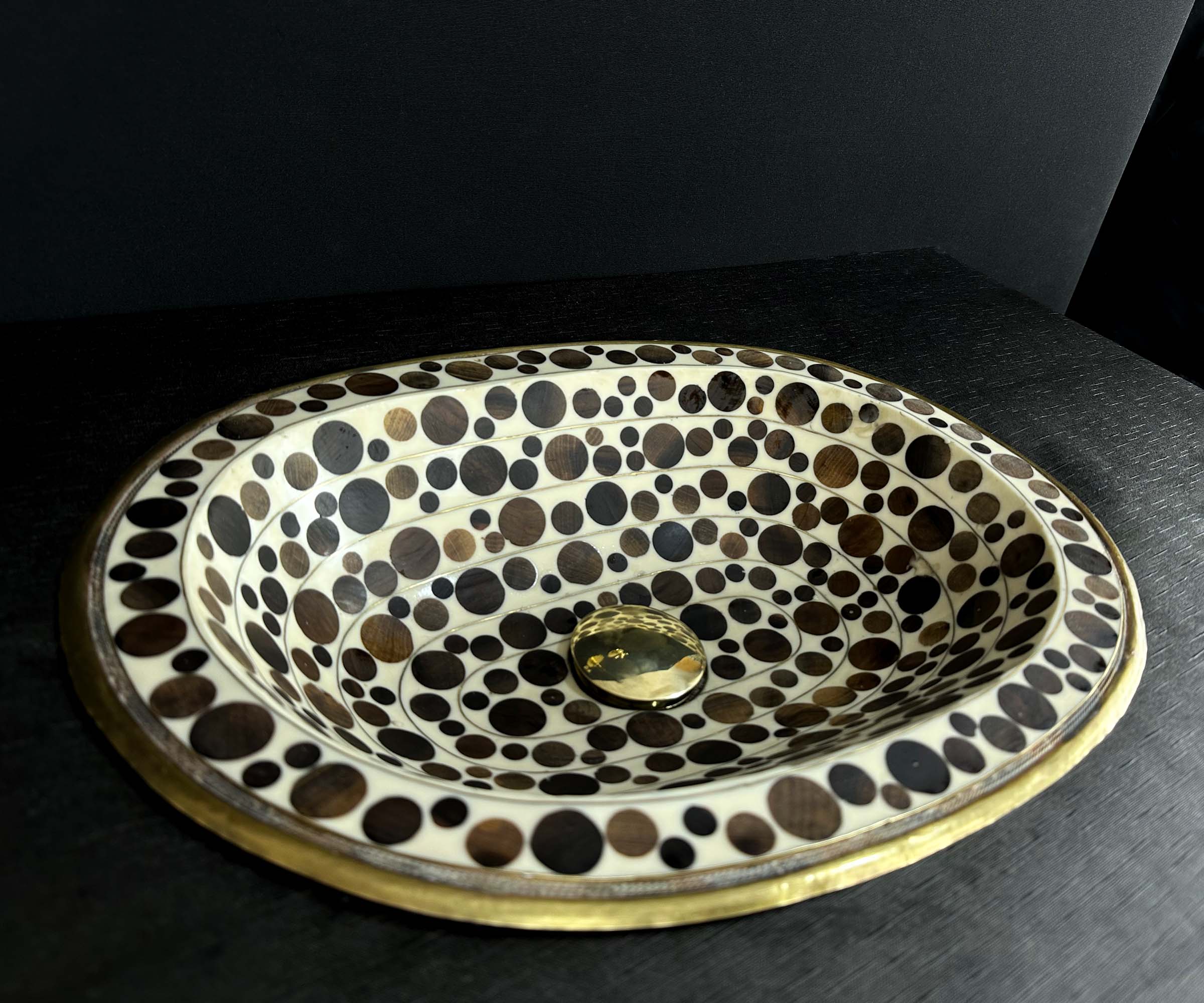 Oval Brass Sink with Circular Wood and White Resin Accents 