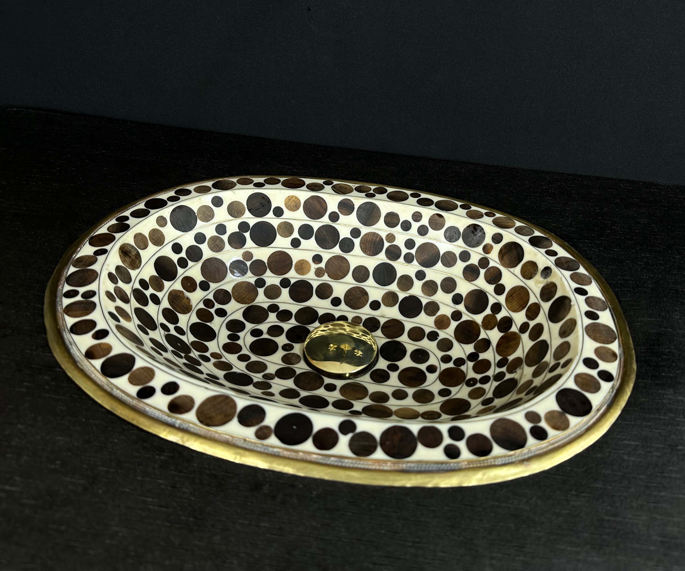 Oval Brass Sink with Circular Wood and White Resin Accents 